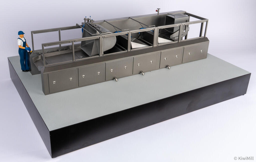 Cooking line scale model at a three-quarter angle, worker figure at the control station by the loading end